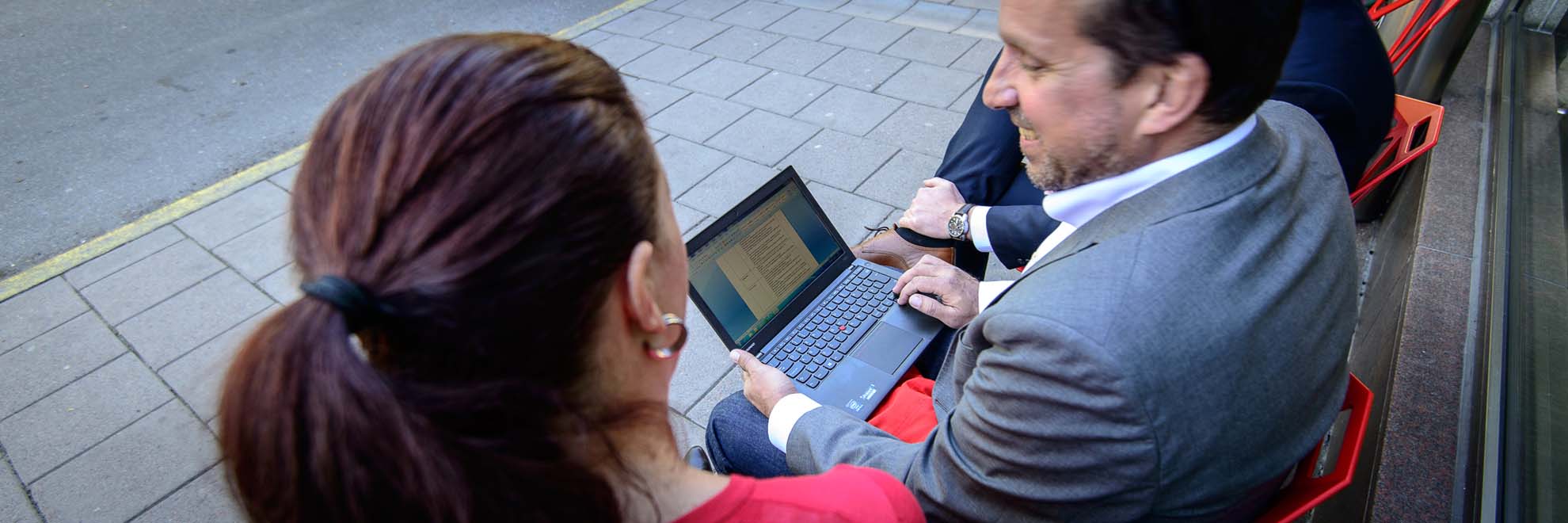 man and woman looking at computer